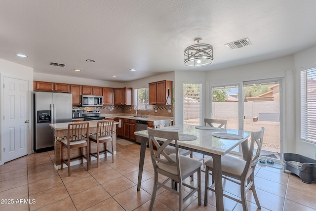 dining area featuring light tile patterned flooring, visible vents, and recessed lighting
