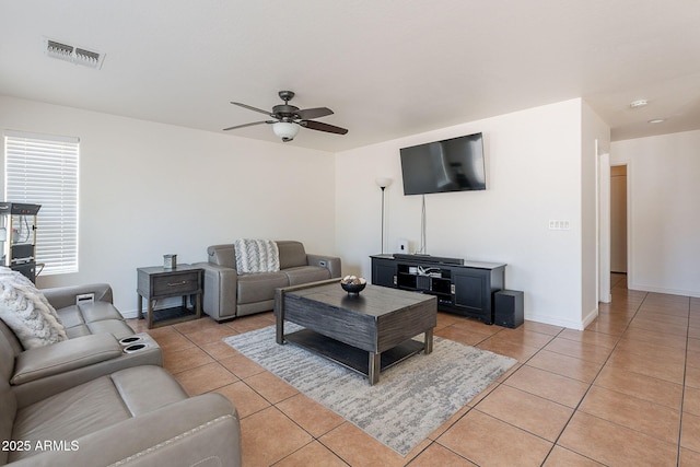 living room featuring visible vents, baseboards, light tile patterned flooring, and ceiling fan