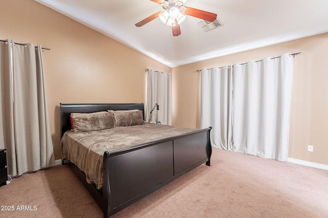 bedroom featuring visible vents, baseboards, ceiling fan, light colored carpet, and vaulted ceiling