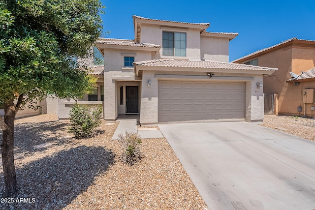 view of front facade featuring concrete driveway, stucco siding, a tile roof, and an attached garage