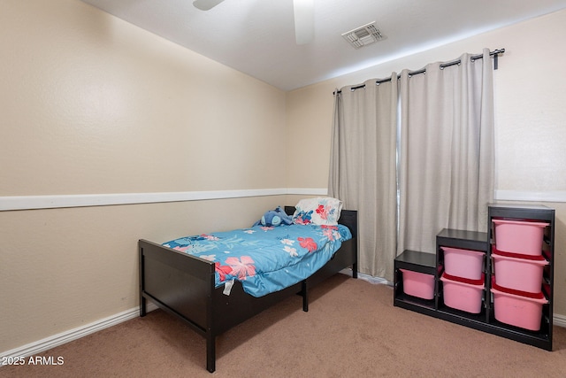 carpeted bedroom with visible vents, baseboards, and a ceiling fan