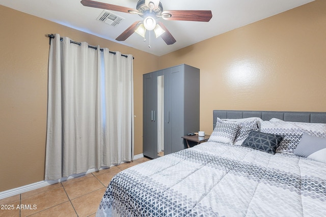 bedroom with ceiling fan, baseboards, light tile patterned floors, and visible vents