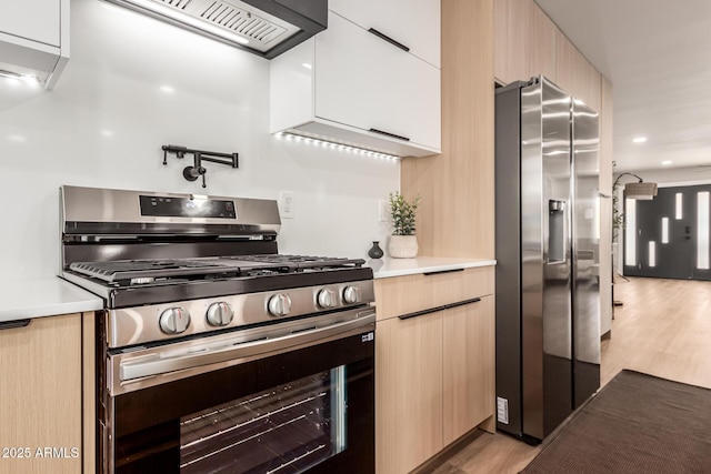 kitchen featuring light hardwood / wood-style flooring, light brown cabinetry, custom exhaust hood, and stainless steel appliances