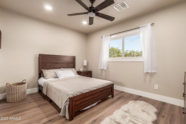 bedroom with wood-type flooring and ceiling fan