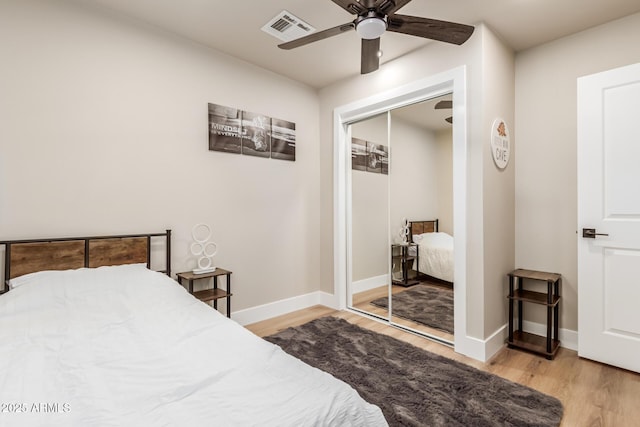 bedroom with a closet, ceiling fan, and light wood-type flooring