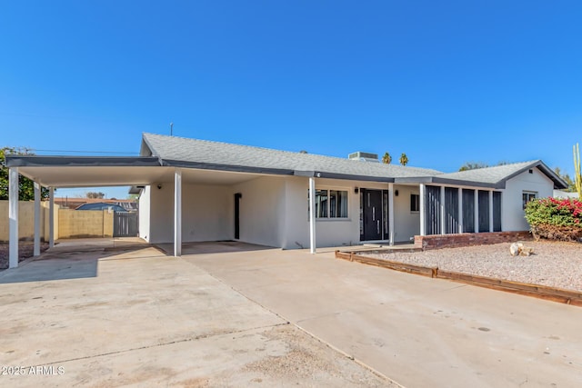 ranch-style home featuring a carport