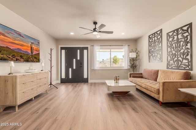 living room featuring wood-type flooring and ceiling fan