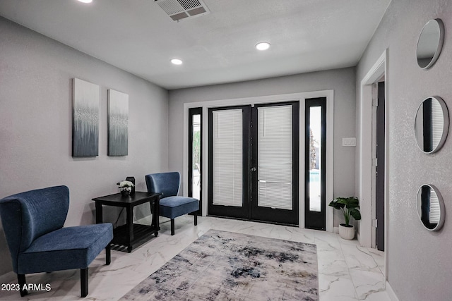 foyer entrance with recessed lighting, visible vents, marble finish floor, and french doors