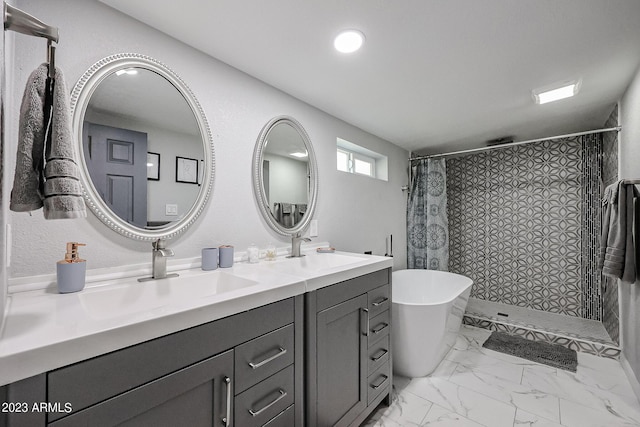 bathroom with a sink, tiled shower, marble finish floor, and double vanity