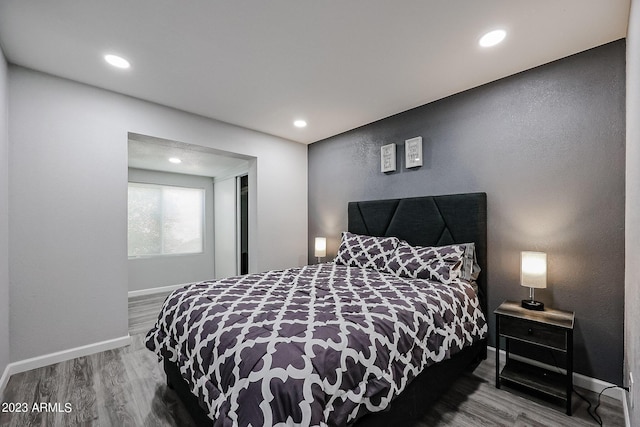 bedroom featuring recessed lighting, wood finished floors, and baseboards