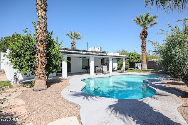 view of swimming pool with a patio, a fenced backyard, a fenced in pool, and ceiling fan