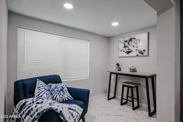 living area featuring recessed lighting, baseboards, and marble finish floor