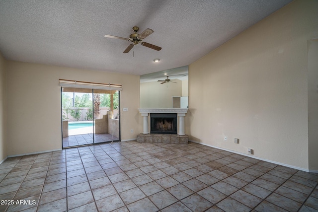 6101 E Beck Ln, Scottsdale, AZ 85254 - unfurnished living room featuring ceiling fan, a textured ceiling, a fireplace with raised hearth, and light tile patterned floors