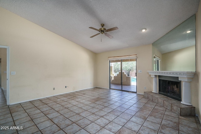 6101 E Beck Ln, Scottsdale, AZ 85254 - unfurnished living room with ceiling fan, vaulted ceiling, a tiled fireplace, and a textured ceiling