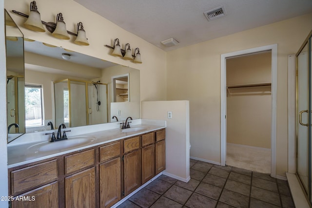 6101 E Beck Ln, Scottsdale, AZ 85254 - bathroom featuring a shower stall, a walk in closet, and double vanity