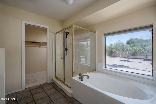 6101 E Beck Ln, Scottsdale, AZ 85254 - full bathroom featuring a bath, a shower stall, a walk in closet, and tile patterned floors