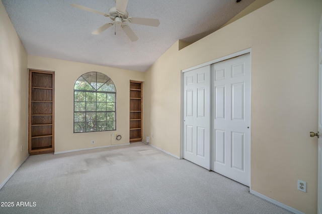 6101 E Beck Ln, Scottsdale, AZ 85254 - unfurnished bedroom with carpet floors, a closet, a textured ceiling, ceiling fan, and vaulted ceiling