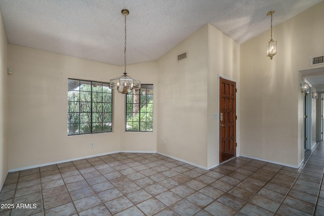 6101 E Beck Ln, Scottsdale, AZ 85254 - spare room featuring a textured ceiling, a chandelier, and lofted ceiling