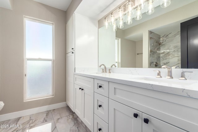 bathroom featuring toilet, a tile shower, a wealth of natural light, and vanity