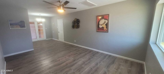 spare room with ceiling fan and dark wood-type flooring