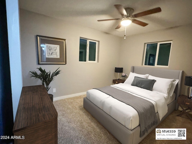 carpeted bedroom featuring baseboards and a ceiling fan