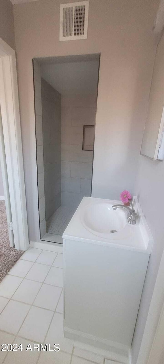 full bath with vanity, tile patterned floors, visible vents, and a stall shower