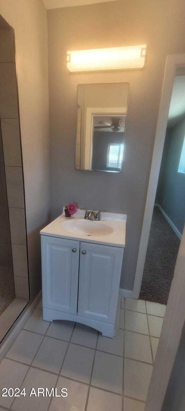 bathroom featuring tile patterned floors, baseboards, and vanity