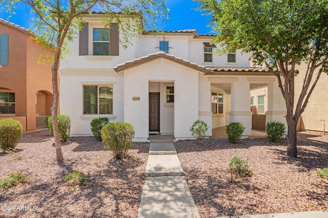 mediterranean / spanish-style house featuring stucco siding and a tile roof