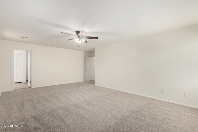 unfurnished room with visible vents, a ceiling fan, baseboards, and light carpet