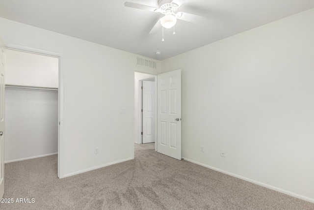 unfurnished bedroom with carpet flooring, baseboards, visible vents, and a closet