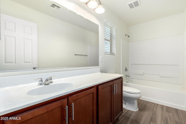 full bathroom with shower / washtub combination, vanity, wood finished floors, and visible vents