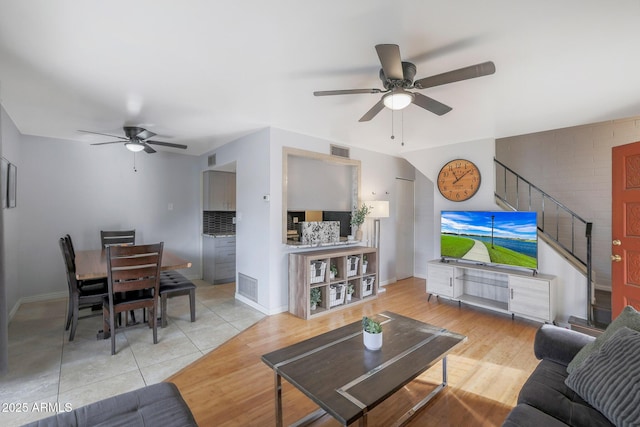 living room with ceiling fan and light tile patterned flooring