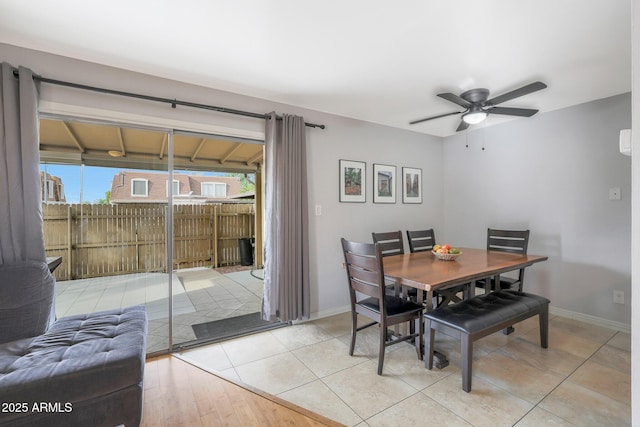 dining space featuring ceiling fan and light tile patterned flooring