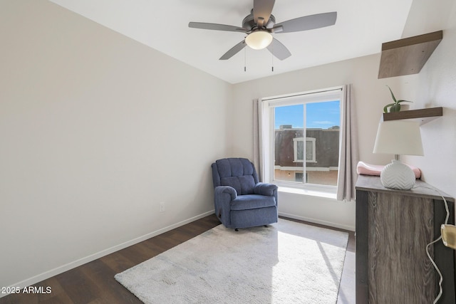 living area with ceiling fan and dark hardwood / wood-style floors