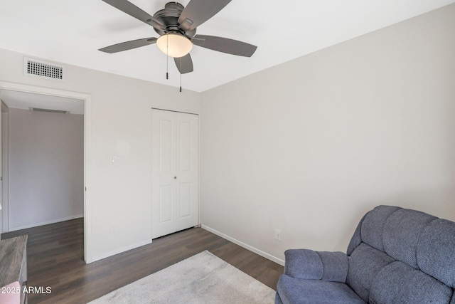 sitting room featuring dark hardwood / wood-style flooring and ceiling fan