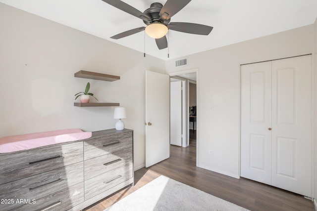 bedroom with ceiling fan, dark hardwood / wood-style flooring, and a closet