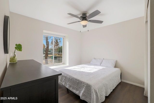 bedroom with dark hardwood / wood-style flooring and ceiling fan