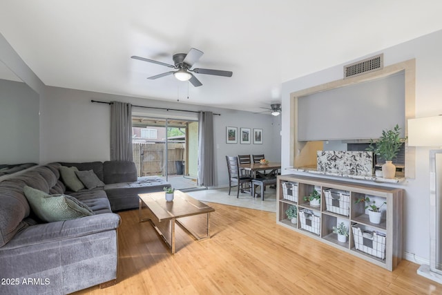 living room featuring hardwood / wood-style flooring and ceiling fan