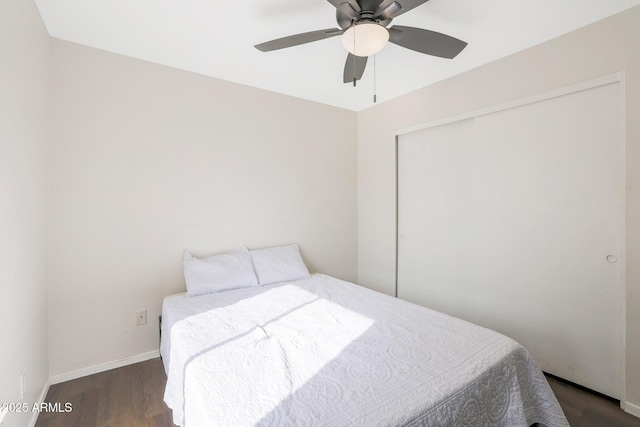 bedroom featuring dark hardwood / wood-style flooring, a closet, and ceiling fan