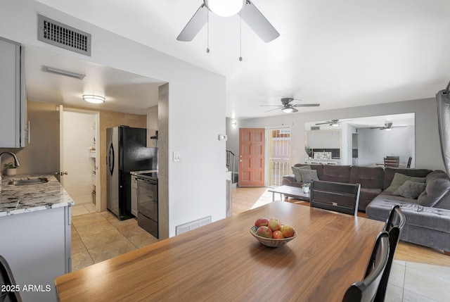 tiled dining space featuring sink