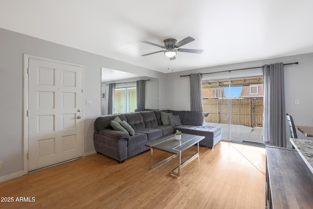 living room with ceiling fan and light hardwood / wood-style floors