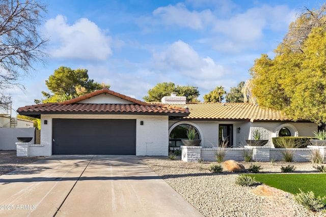 mediterranean / spanish house with a garage