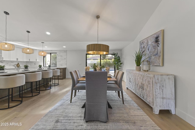 dining room featuring sink and light hardwood / wood-style floors