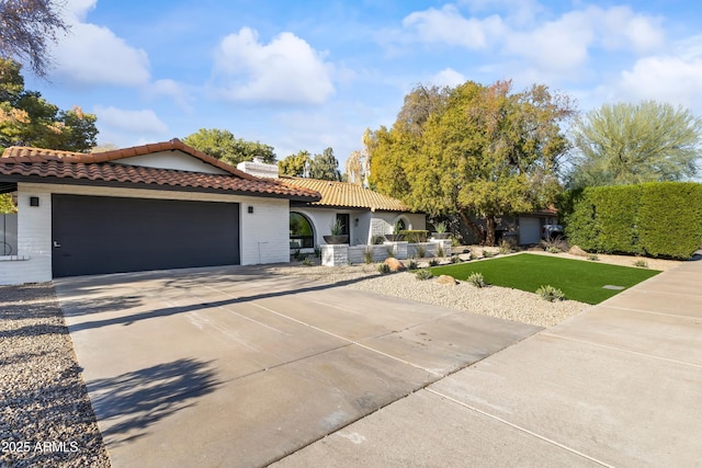 mediterranean / spanish-style house with a garage