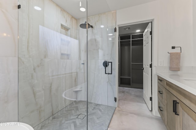 bathroom with vanity and a shower with shower door