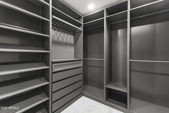 spacious closet featuring light tile patterned floors