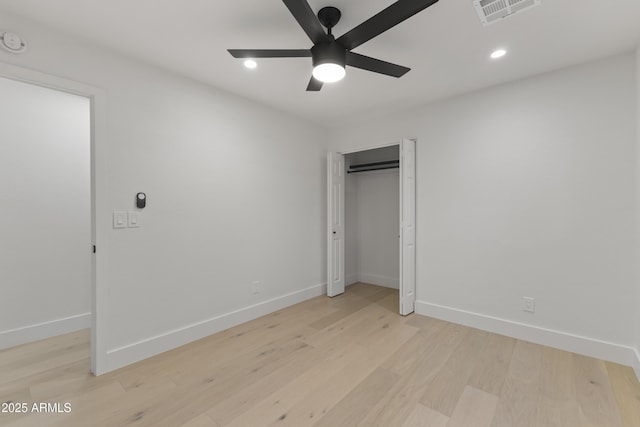 unfurnished bedroom featuring a closet, ceiling fan, and light hardwood / wood-style flooring