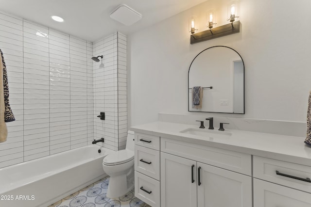 full bathroom featuring vanity, tiled shower / bath combo, and toilet