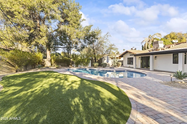 view of swimming pool featuring a patio and a yard