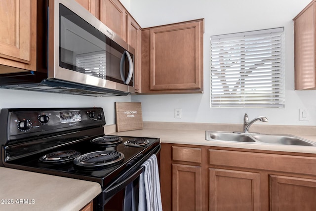 kitchen with black electric range and sink